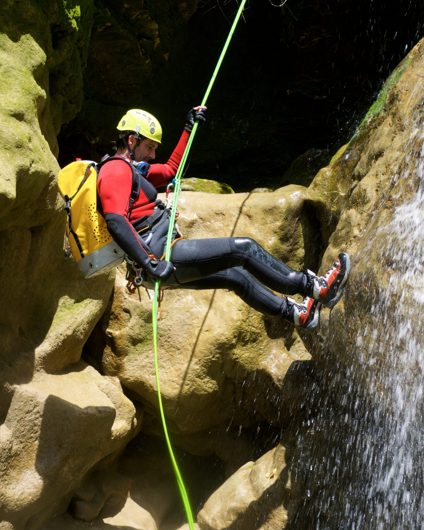 Outdoor canyoneering activity featuring waterfall rappelling and adventure travel.